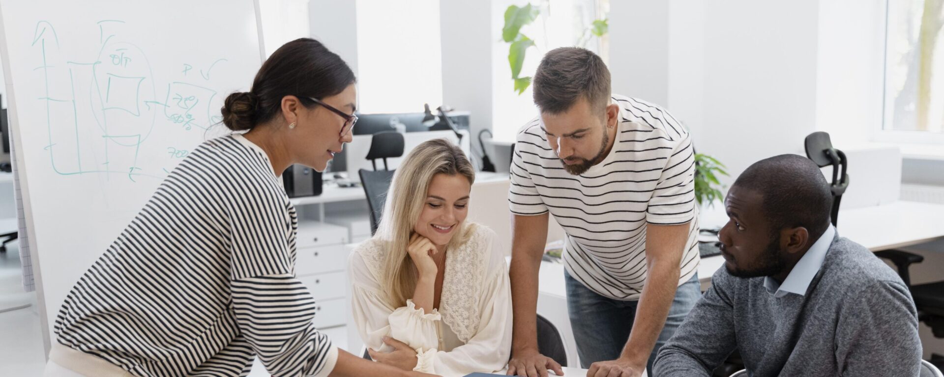 4 personnes autour d'une table en train de réfléchir
