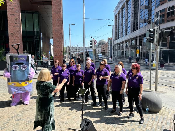 Kingswood community choir singing on the Luas network